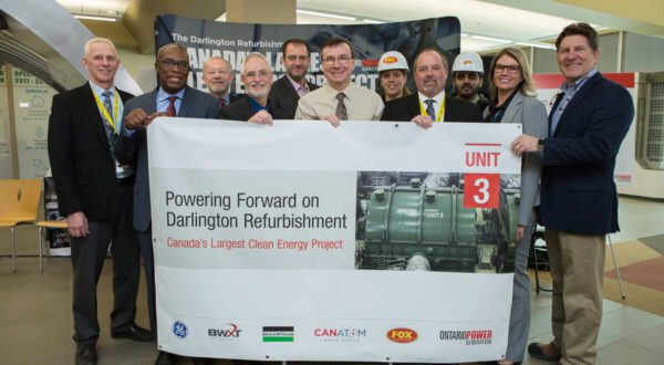 Jeff Lyash (right) and refurb team members at the Feb. 15 press conference.