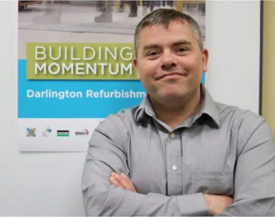 Radiation protection manager Joe Cicchini stands smiling with his arms crossed.