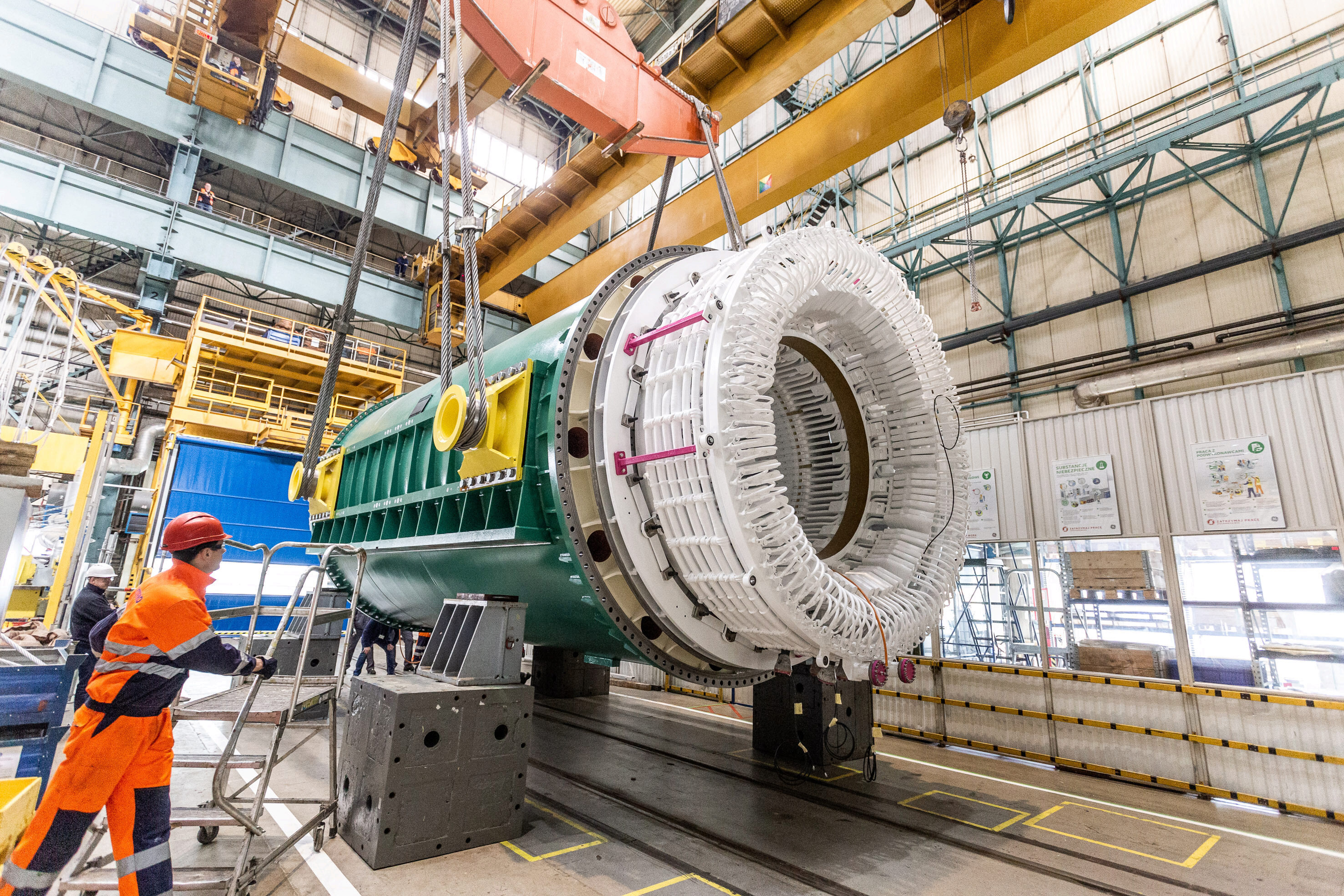 Workers at a GE plant in Poland prepare a massive generator stator for shipment to Darlington Nuclear.