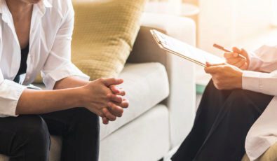 Doctor or psychiatrist consulting and diagnostic examining stressful woman patient on mental health in medical clinic or hospital healthcare service center.