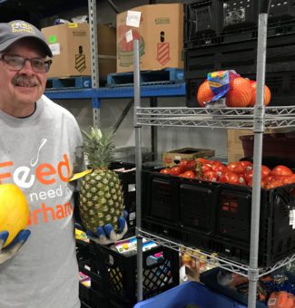 A worker with Feed the Need Durham setting up food deliveries.