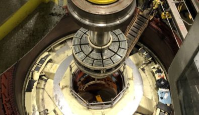 The generator shaft is lowered into Unit 7 during its reassembly at R.H. Saunders GS.