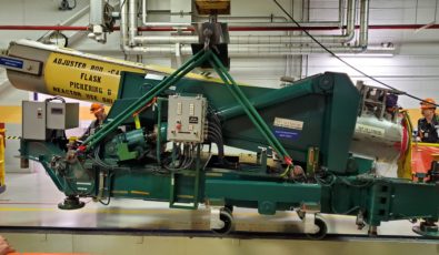 A flask positioner is maneuvered to extract a Cobalt-60 adjuster rod from the reactor at Pickering Nuclear GS.