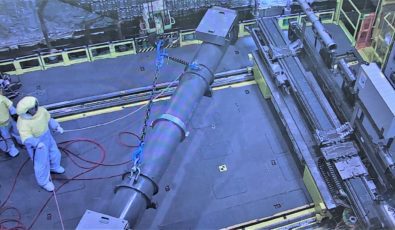 A 13,600-kilogram flask loaded with a pressure tubes, a calandria tube, and four garter springs is hoisted in the Darlington Unit 3 vault.