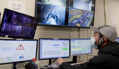 An employee observes refurbishment work on a number of monitors.