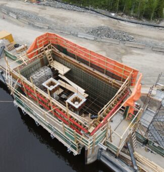 Exterior of Smoky Falls GS with construction activities underway