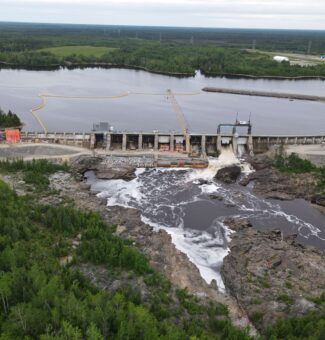 Exterior of Smoky Falls GS with construction activities underway