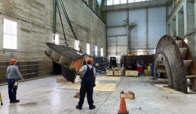 Workers stand by as a section of R.H. Saunders GS's Unit 9 inner head cover is lifted.