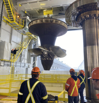 The massive turbine runner is pulled up from R.H. Saunders GS's G9 unit, the first of the station's 16 units to be refurbished.