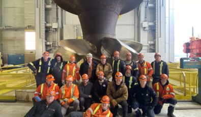 The team at R.H. Saunders GS pose in front of the massive runner assembly after it was lifted from the G9 unit.