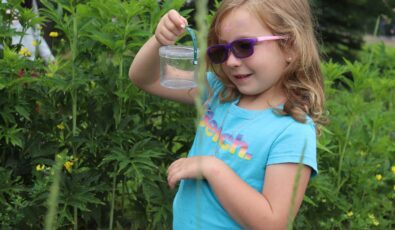 A young visitor enjoys the River Institute's pollinator event at the Saunders Hydro Dam Visitor Centre.