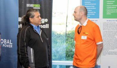 A member of the DNNP team speaking to a community member at the 2022 Open House