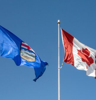 An Alberta and Canada flag waving.