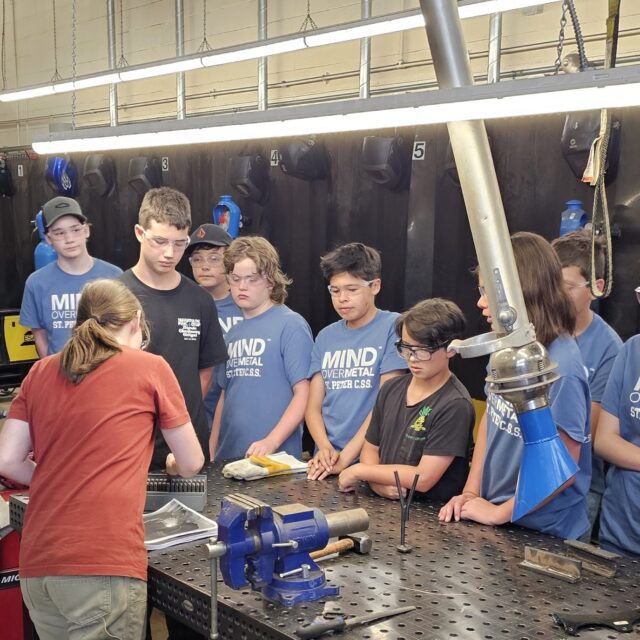 Students listen to instruction at the Mind Over Metal camp.