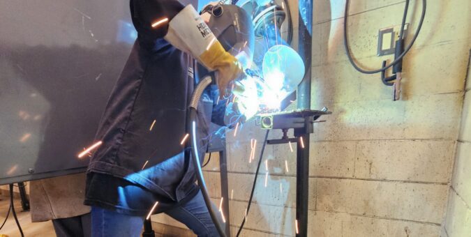 A student gets hands-on with a welding demonstration at the Mind Over Metal camp.