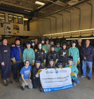 Students and instructors pose for a photo during the Mind Over Metal camp.