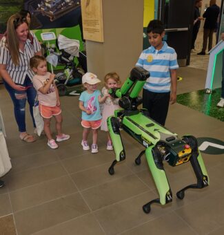Kids greet a Boston Dynamics robot dog at OPG's 2024 Community Power Expo. The annual event at Darlington Nuclear welcomed more than 3,200 visitors.