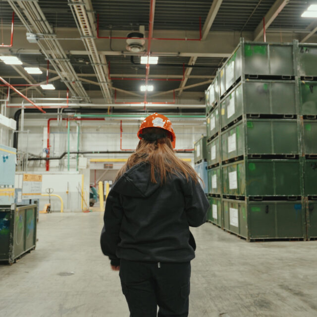 Employee walking through nuclear waste management facility