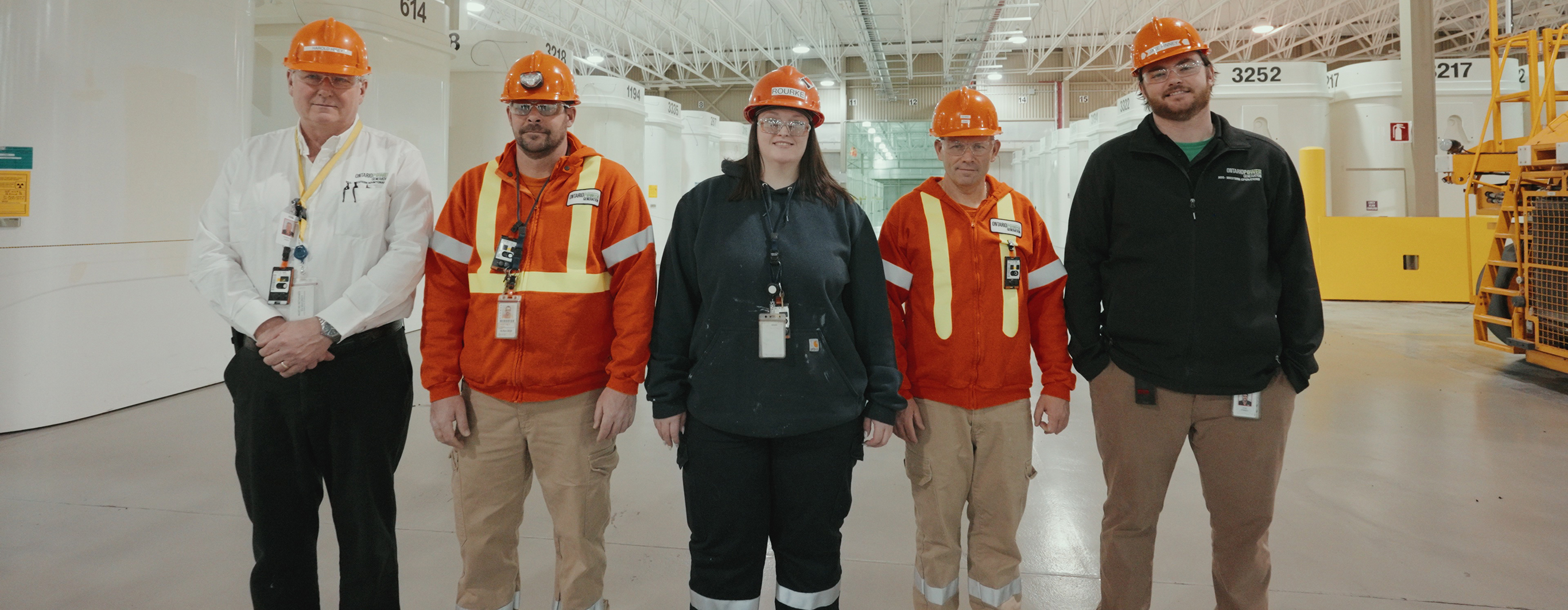 Nuclear Sustainability Services employees facing camera in a high-level waste facility.