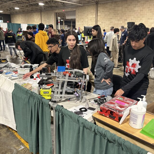 Students make some final adjustments to their robots at the 2025 Skills Ontario Competition.